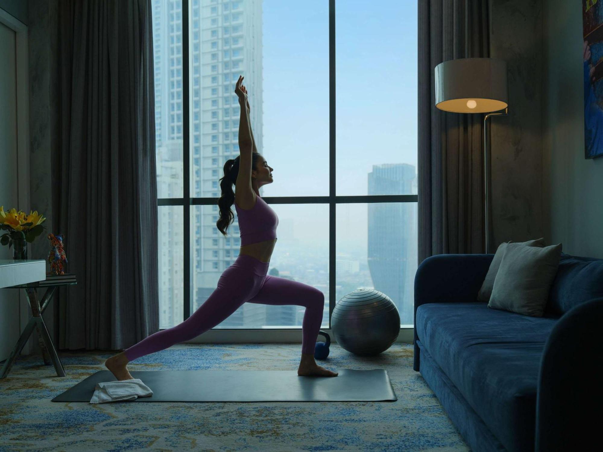 Pullman Jakarta Central Park Екстериор снимка A woman practicing yoga at home